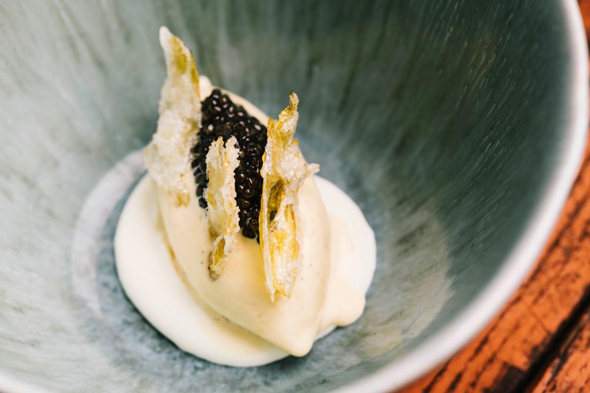 Brown butter miso ice cream with caviar and candied celery leaves. (Dani Sykes Photography)