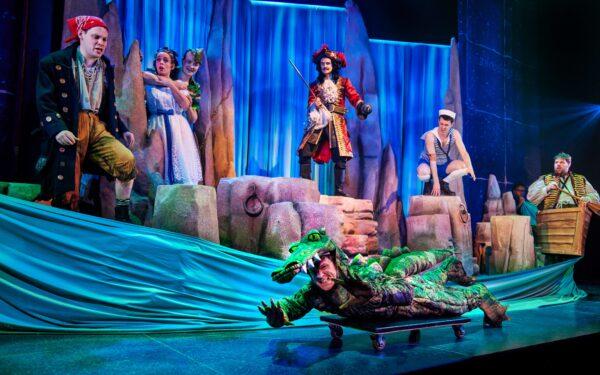 Max, front (Matthew Cavendish) with (L–R) Francis (Harry Kershaw), Sandra (Charlie Russell), Jonathan (Greg Tannahill), Chris (Henry Shields), Dennis (Jonathan Sayer), and Robert (Henry Lewis), in “Peter Pan Goes Wrong.” (Jeremy Daniel)