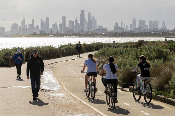 People walk and ride along the beach at Brighton in Melbourne, Australia, on May 13, 2020. (Daniel Pockett/Getty Images)