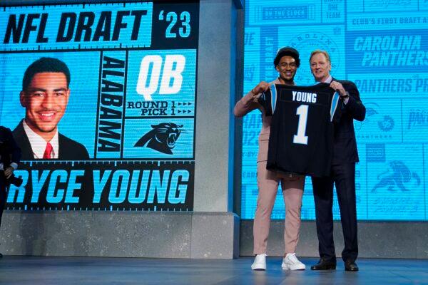 Alabama quarterback Bryce Young gets a jersey from NFL Commissioner Roger Goodell after being chosen by Carolina Panthers with the first overall pick during the first round of the NFL football draft in Kansas City, Mo., on April 27, 2023. (Jeff Roberson/AP Photo)
