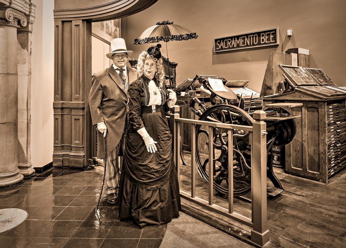 Tour guides Shawn Taylor and Jane Hastings in front of recreated 1850s to 1860s print shop exhibit in Sacramento History Museum. (Maria Coulson)