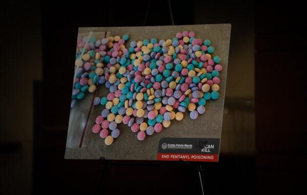 A poster of candy-like fentanyl pills is put on display at a news conference held by Orange County officials supporting state bills combating fentanyl poisoning in Irvine, Calif., on April 28, 2023. (John Fredricks/The Epoch Times)
