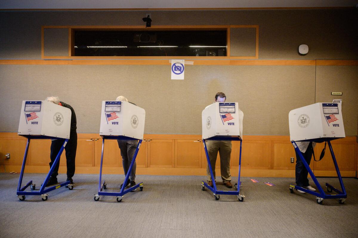 Voters stand in booths at a voting station, in this file photo. (Ed Jones/AFP via Getty Images)