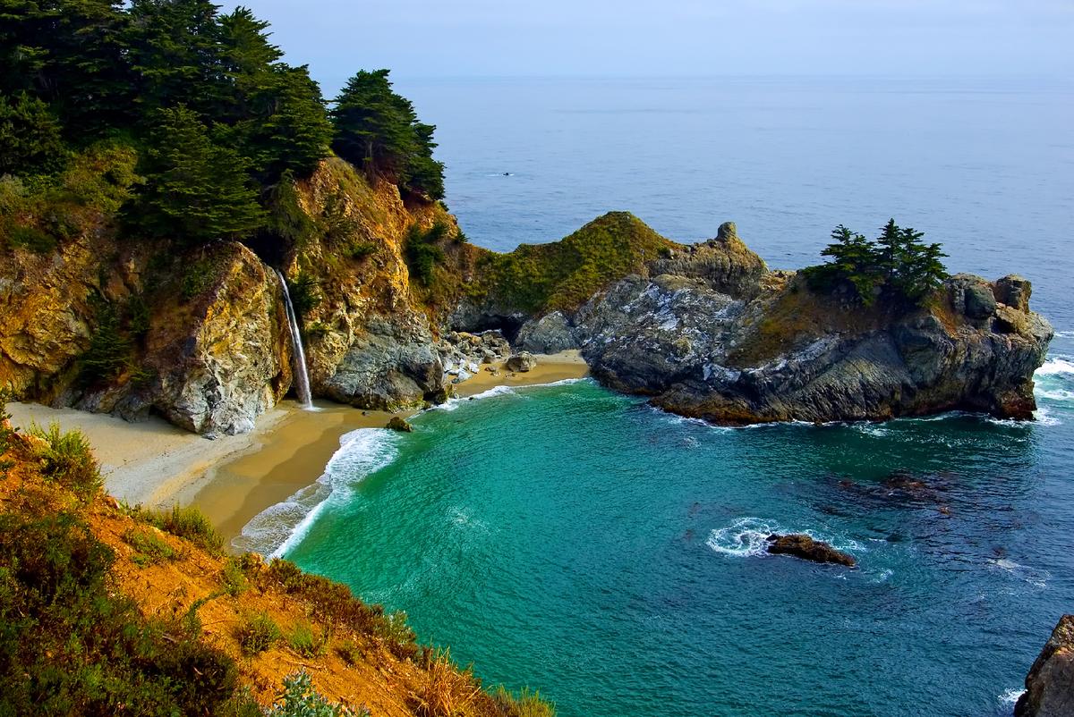 McWay Falls in the Julia Pfeiffer Burns State Park in California, spills over copper-colored cliffs onto a Pacific Ocean beach. (Courtesy of Photoquest/Dreamstime.com)