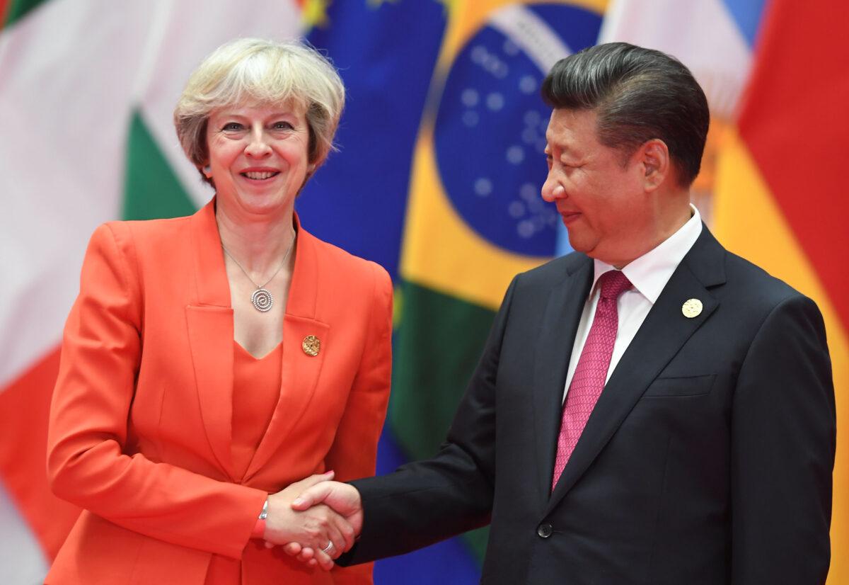 Britain's Prime Minister Theresa May shakes hands with China's leader Xi Jinping (R) before the G20 leaders' family photo in Hangzhou, China, on Sept. 4, 2016. (Greg Baker/AFP via Getty Images)