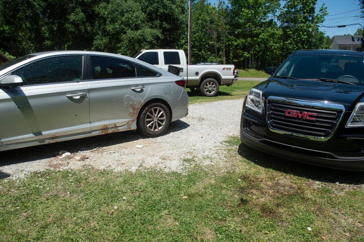 Vehicles with bullet holes are parked outside a Bay St. Louis, Miss., residence where several high school students were shot, some fatally, at a house party early on April 30, 2023. (Hannah Ruhoff/The Sun Herald)/The Sun Herald via AP)