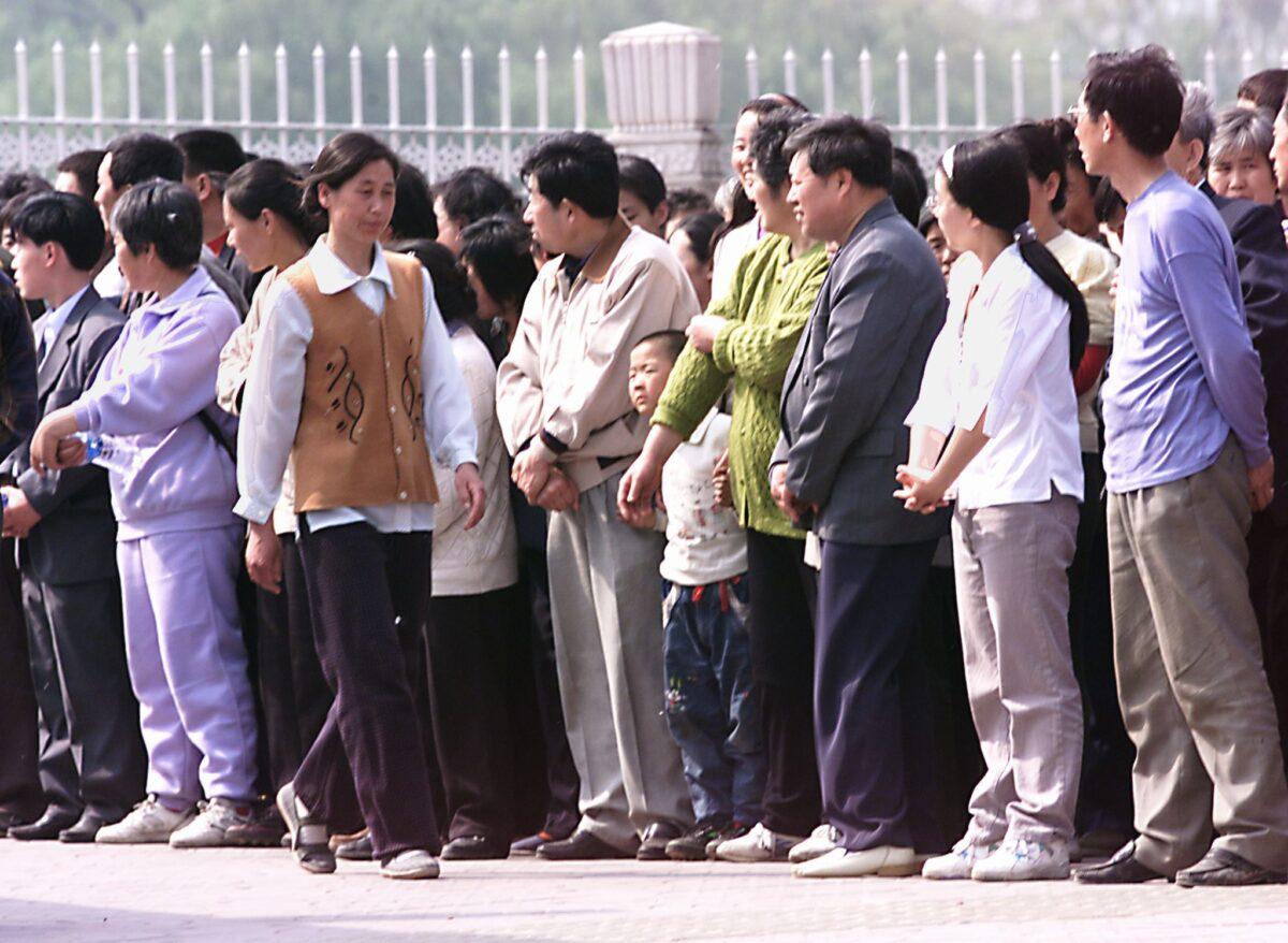 Thousands of Falun Gong practitioners line up on the street outside Zhongnanhai, the seat of power of China's central government in Beijing, in a peaceful protest on April 25, 1999. (Goh Chai Hin / AFP via Getty Images)