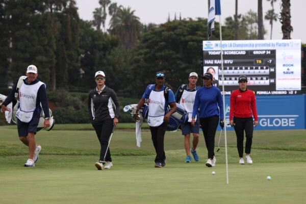 Xiyu Lin (L-R) of China, Aditi Ashok of India and Hannah Green of Australia walk across the 18th green in a playoff during the final round of the JM Eagle LA Championship presented by Plastpro at Wilshire Country Club in Los Angeles on April 30, 2023. (Harry How/Getty Images)