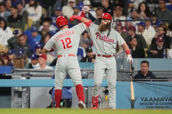 Philadelphia Phillies' Kyle Schwarber (12) celebrates with Brandon Marsh after hitting a home run during the fourth inning of a baseball game against the Los Angeles Dodgers in Los Angeles, on May 1, 2023. (Ashley Landis/AP Photo)