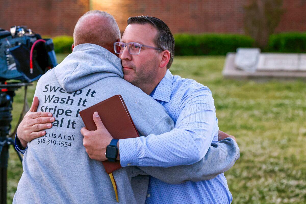 Pastor Ryan Wells hugs Nathan Brewer, the father of Brittany Brewer who was found dead, after a vigil in Henryetta, Okla., on May 1, 2023. (Nathan J. Fsh/The Oklahoman via AP)