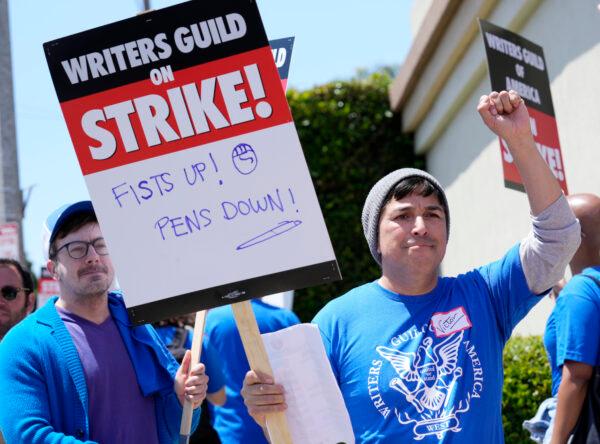 Writers Guild of America West member Victor Duenas pickets with others at an entrance to Paramount Pictures in Los Angeles on May 2, 2023. (Chris Pizzello/AP Photo)