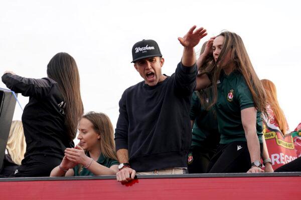 Wrexham Co-Owner Rob McElhenney celebrates with members of the Wrexham FC soccer team the promotion to the Football League in Wrexham, Wales, on May 2, 2023. (Martin Rickett/PA via AP)