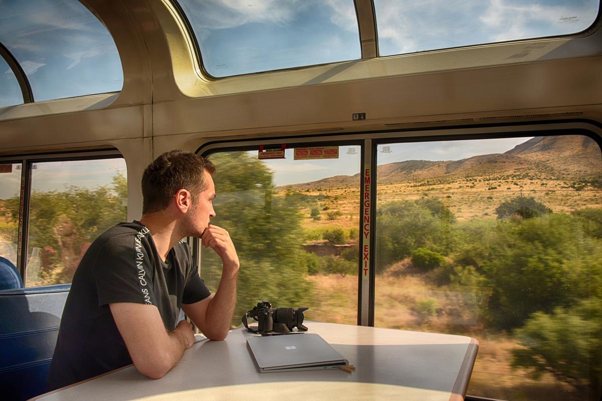A passenger watches the scenery roll by on board the Sunset Limited. (Courtesy of Amtrak)