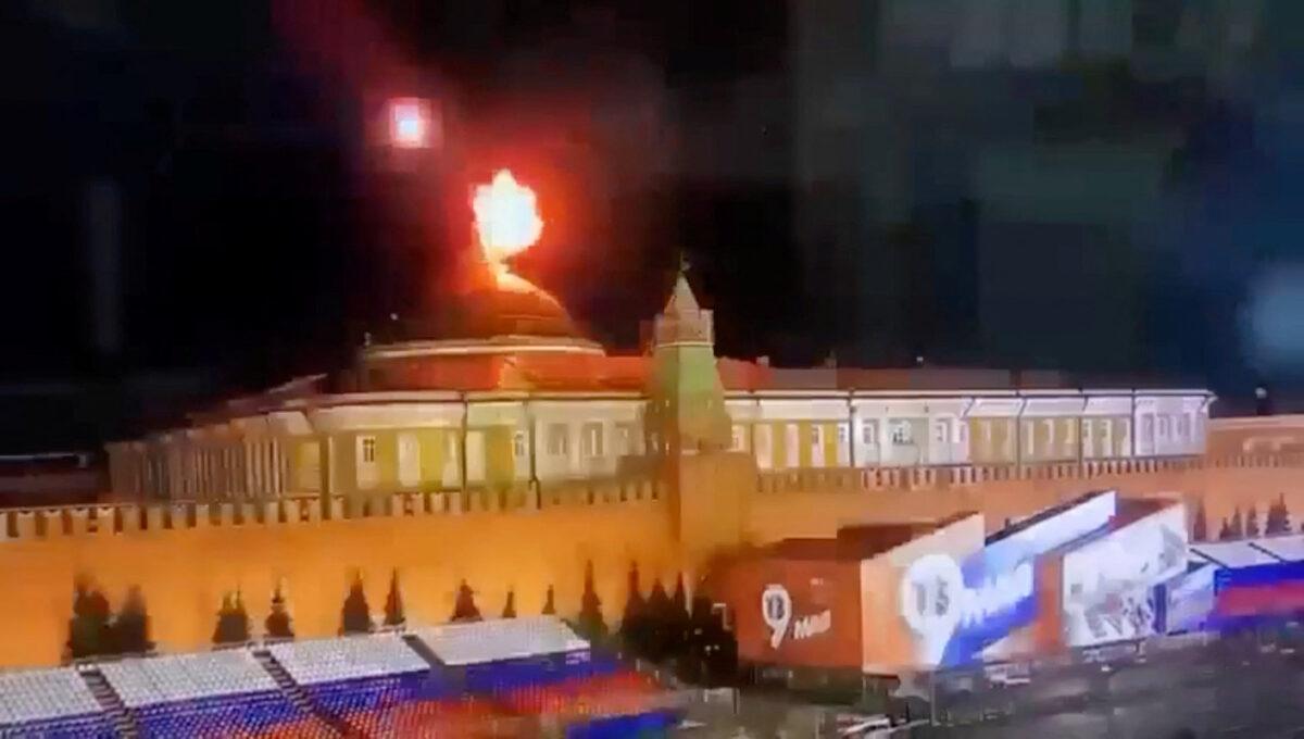 A still image taken from video shows a flying object exploding in an intense burst of light near the dome of the Kremlin Senate building during a reported drone attack in Moscow, Russia, on May 3, 2023. (Ostorozhno Novosti/Handout via Reuters)