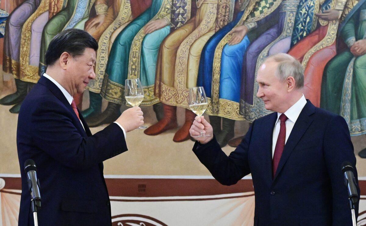 Russian President Vladimir Putin and Chinese leader Xi Jinping make a toast during a reception following their talks at the Kremlin in Moscow on March 21, 2023. (Pavel Byrkin/Sputnik/AFP via Getty Images)