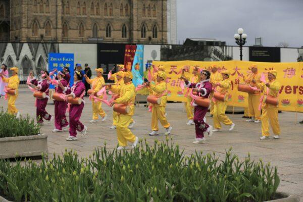 Falun Dafa adherents present a performance with waist drums to celebrate World Falun Dafa Day on Parliament Hill in Ottawa on May 3, 2023. (Jonathan Ren/The Epoch Times)