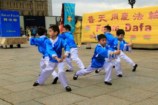 Young Falun Dafa adherents present a performance to celebrate World Falun Dafa Day on Parliament Hill in Ottawa on May 3, 2023. (Jonathan Ren/The Epoch Times)