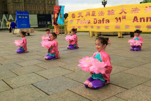 Young Falun Dafa adherents present a performance to celebrate World Falun Dafa Day on Parliament Hill in Ottawa on May 3, 2023. (Jonathan Ren/The Epoch Times)