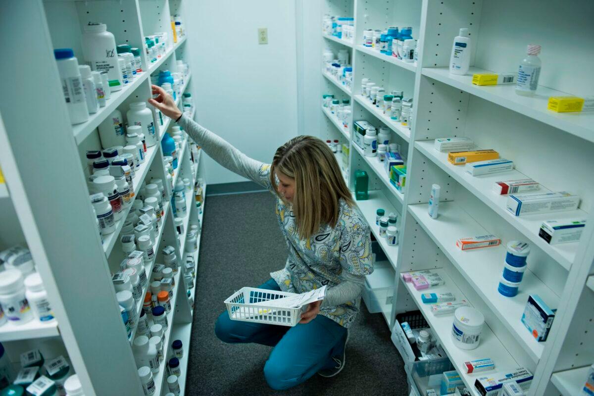 A staff member sorts through drugs while filling a prescription at the Clay-Battelle Community Health Center's pharmacy in Blacksville, W.Va., on March 21, 2017. (Brendan Smialowski/AFP via Getty Images)
