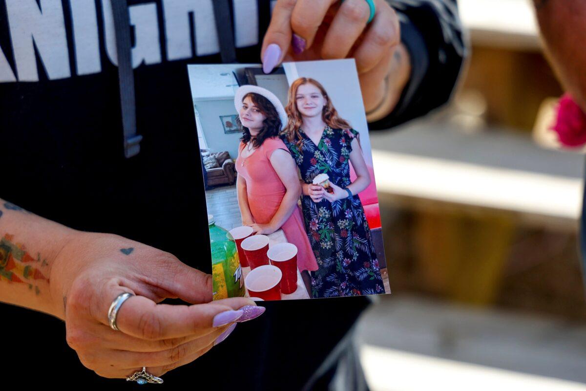 Ashleigh Webster shows a photo of Ivy Webster and Tiffany Guess at her home in Henryetta, Okla., on May 2, 2023. (Nathan J. Fish/The Oklahoman via AP)