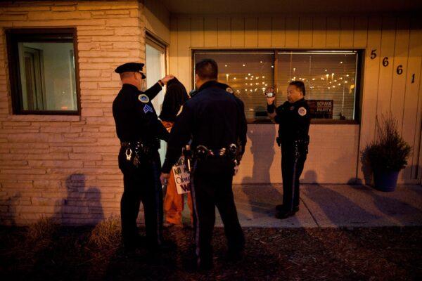 A protester affiliated with the Occupy Wall Street movement is arrested by members of the Des Moines police department for blocking an entrance to the Iowa Democratic Party headquarters in Des Moines, Iowa, on Dec. 29, 2011. (Andrew Burton/Getty Images)