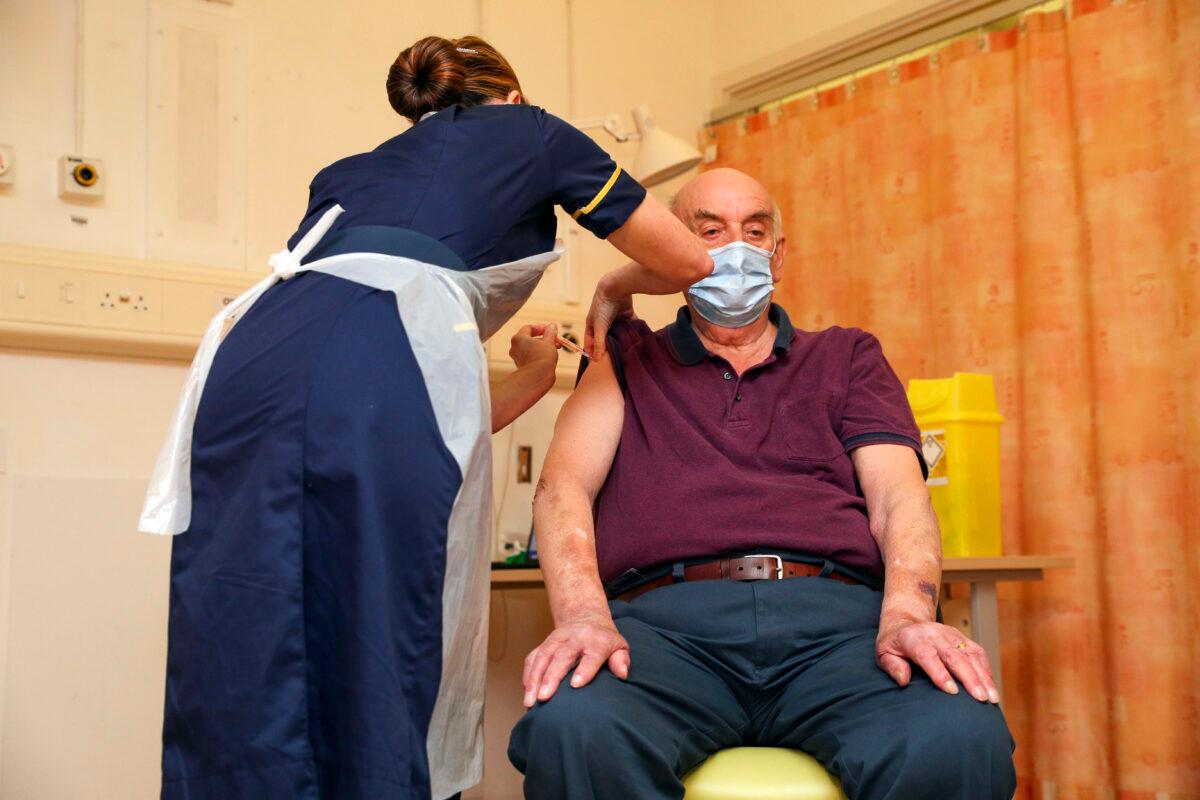 A man receives the Oxford University/AstraZeneca COVID-19 vaccine from a nurse in Oxford, England, on Jan. 4, 2021. (Steve Parsons - WPA Pool/Getty Images)