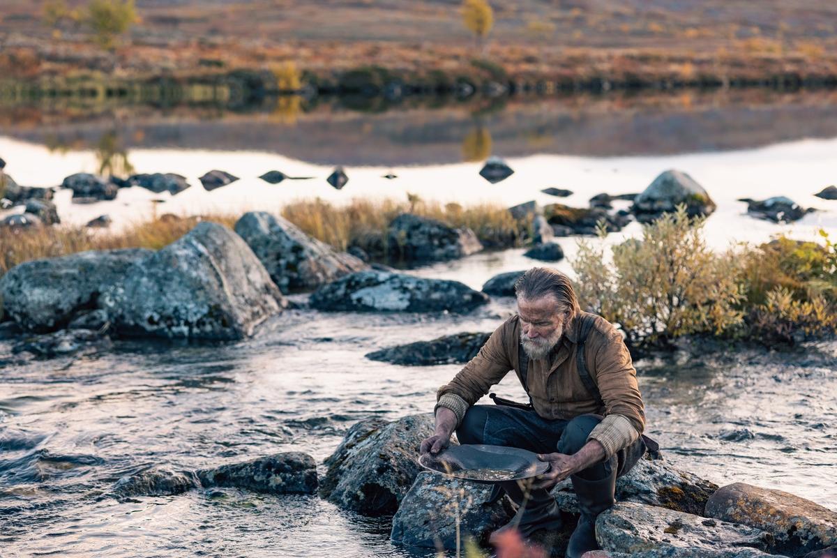 Aatami (Jorma Tommila) panning for gold in the hinterlands of Finland, <span class="sc-afe43def-1 fDTGTb">in "Sisu." (Stage 6 Films)</span>