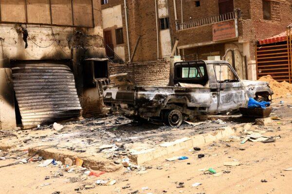 A damaged car and buildings are seen at the central market during clashes between the paramilitary Rapid Support Forces and the Sudanese army in Khartoum North, Sudan, on April 27, 2023. (Mohamed Nureldin Abdallah/Reuters)