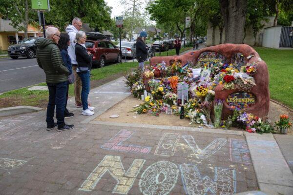 People view a memorial set up at the compassion bench to honor David Henry Breaux, 50, who was found stabbed to death in Central Park in Davis, Calif., on May 1, 2023. (Paul Kitagaki Jr./The Sacramento Bee via AP)