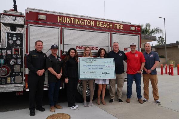 The Huntington Beach Firefighters Association presented a $2,000 check, during the recent screenings, to the Andy Valenta Melanoma Foundation in support of its ongoing work in Huntington Beach, Calif., on April 30, 2023. (Sophie Li/The Epoch Times)