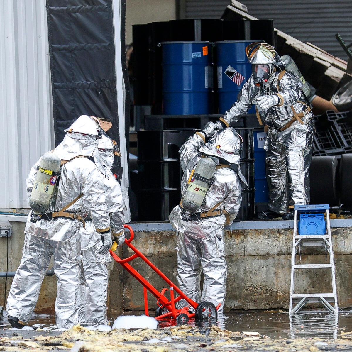 A hazmat team carefully removes barrels from an explosion site in Newburyport, Mass., on May 4, 2023. (Keith Sullivan/The Newburyport Daily News via AP)