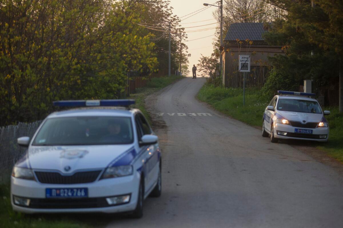 Police officers guard a road in the village of Dubona, some 50 kilometers (30 miles) south of Belgrade, Serbia, on May 5, 2023, as they block the road near the scene of a Thursday night attack. (Armin Durgut/AP Photo)