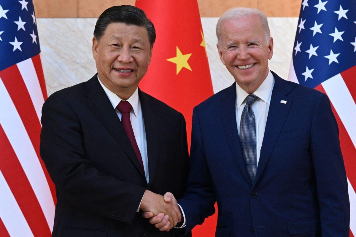 U.S. President Joe Biden (right) and Chinese leader Xi Jinping (left) shake hands as they meet on the sidelines of the G20 Summit in Nusa Dua on the Indonesian resort island of Bali on Nov. 14, 2022. (Saul Loeb/AFP via Getty Images)