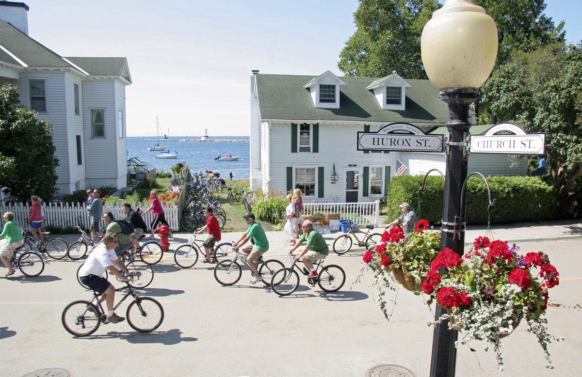 A group of people ride bikes on Mackinaw Island, Michigan. No cars are allowed on Mackinaw Island. People either walk, ride bikes, or ride in horse carriages. (Dreamstime/TNS)