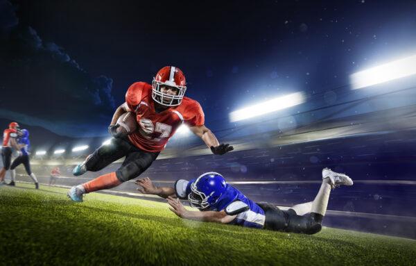 American football players in the action grand arena. (Eugene Onischenko/Shutterstock)