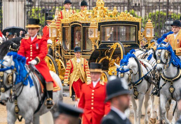 King Charles III and Queen Consort Camilla are carried in the Diamond Jubilee State Coach as the king's procession passes Parliament Square ahead of the coronation at Westminster Abbey in London, on May 6, 2023. (Jane Barlow - WPA Pool/Getty Images)