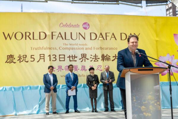 Dean Baxendale, president and CEO of Optimum Publishing International, speaks at a rally outside Toronto City Hall on May 6, 2023, to mark the 31st anniversary of the public introduction of Falun Dafa. (Evan Ning/The Epoch Times)
