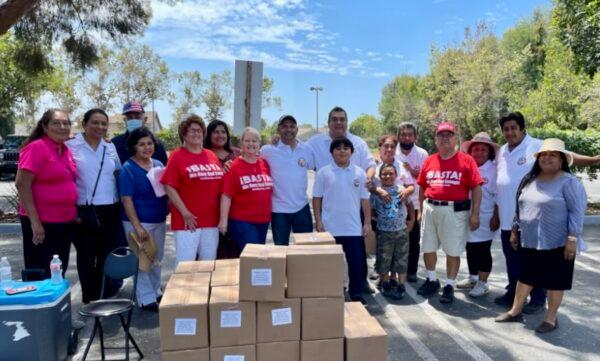 Volunteers at ¡BASTA!, a voter nonprofit based in Santa Ana with a mission to register minority voters, pose for a photo during a food drive. (Courtesy of Ron Flores)