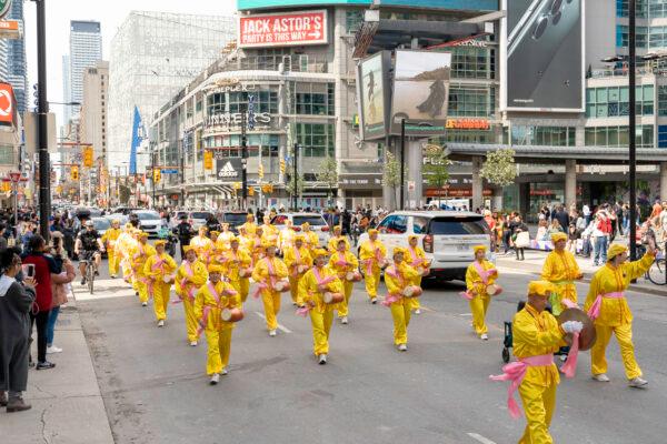 Falun Dafa adherents participate in a parade in downtown Toronto on May 6, 2023, marking the 31st anniversary of the public introduction of the spiritual practice in China on May 13, 1992. (Allen Zhou/The Epoch Times)