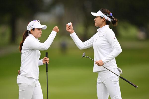 Hye Jin Choi (L) and In Gee Chun (R) of Team Republic of Korea celebrate after a putt on the eighth green during day three of the Hanwha LIFEPLUS International Crown at TPC Harding Park in San Francisco on May 6, 2023. (Orlando Ramirez/Getty Images)