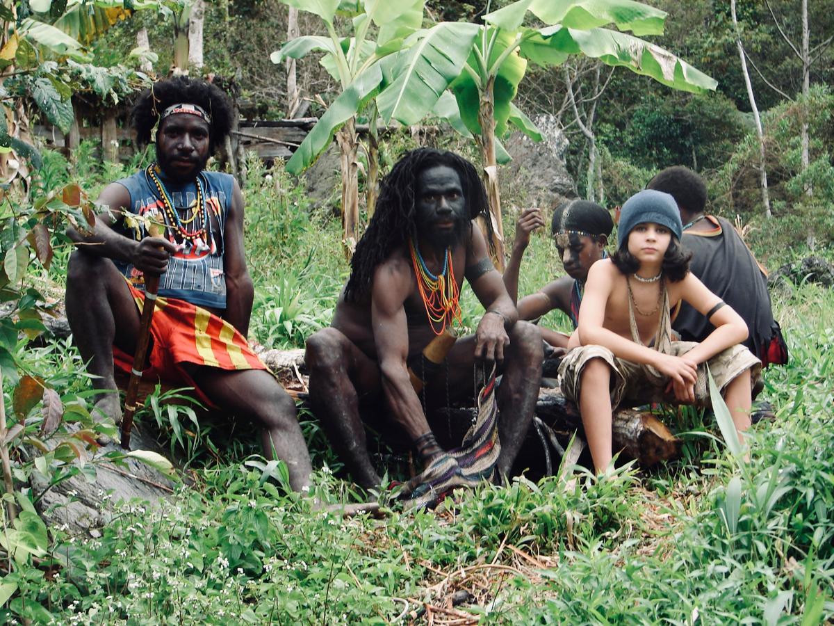 Morgan Wild and several of the Wano spending time together in the jungles of Papua, Indonesia. (Courtesy of <a href="https://www.wildbrothersproductions.com/off-the-couch-into-creation">The Wild Brothers</a>)