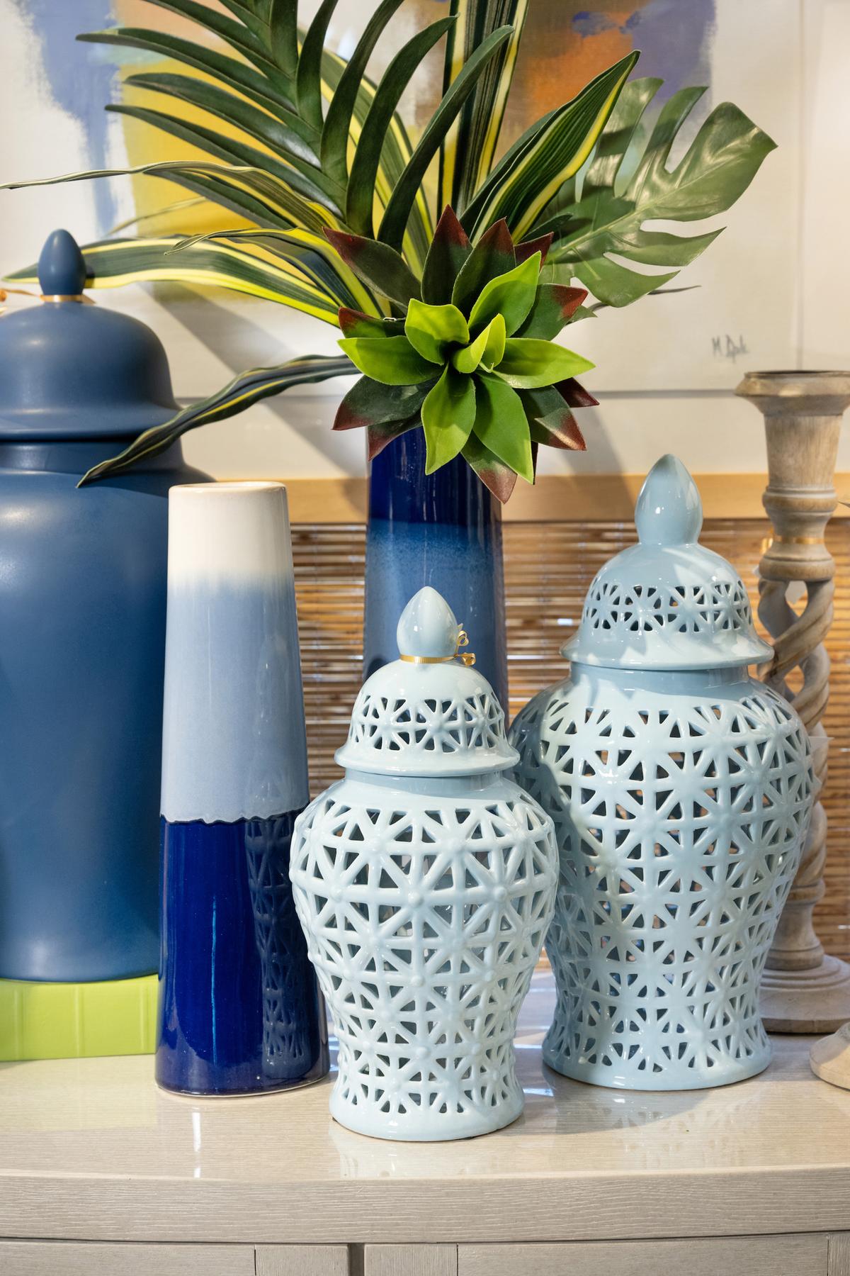 These lidded vases with geometric cutouts add whimsical texture to a tabletop display. (Handout/TNS)