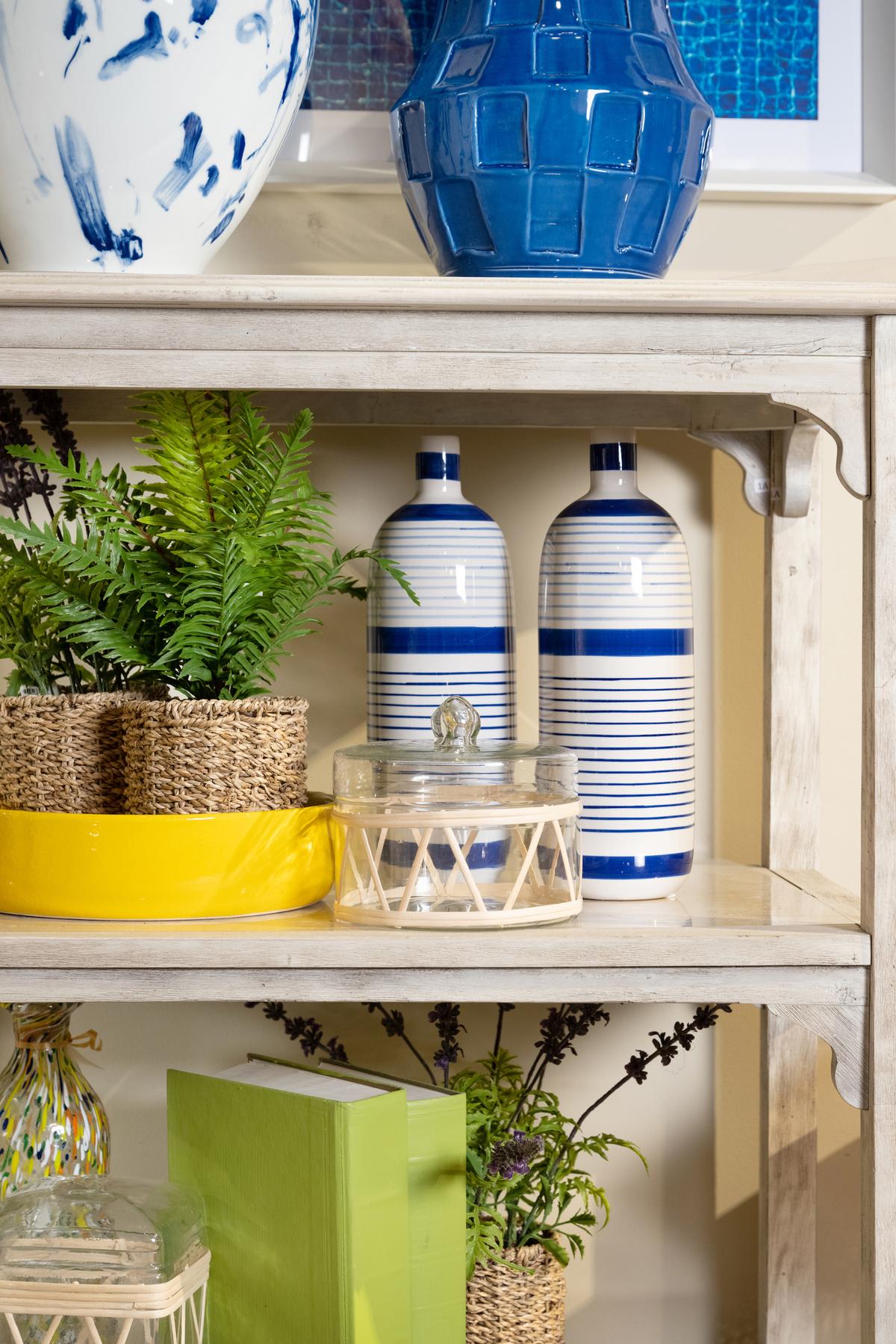 Rattan and glass canisters add texture and interest to a cheery shelf. (Handout/TNS)