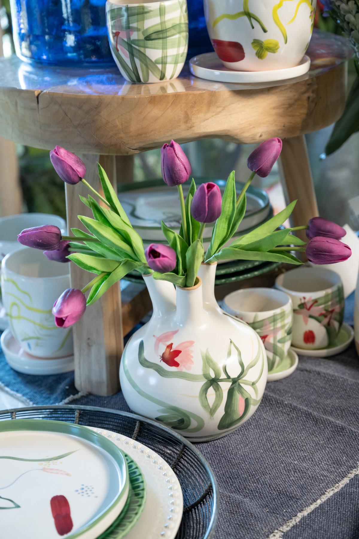 A hand-painted bud vase is a creative way to display a spray of tulips. (Handout/TNS)