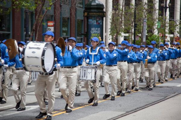 Members of the Tian Guo Marching Band march in a parade in San Francisco on May 6, 2023, to celebrate World Falun Dafa Day. (Lear Zhou/The Epoch Times)