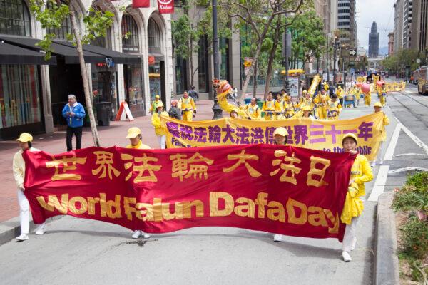 Falun Dafa practitioners march in a parade in San Francisco on May 6, 2023, to celebrate World Falun Dafa Day. (Lear Zhou/The Epoch Times)