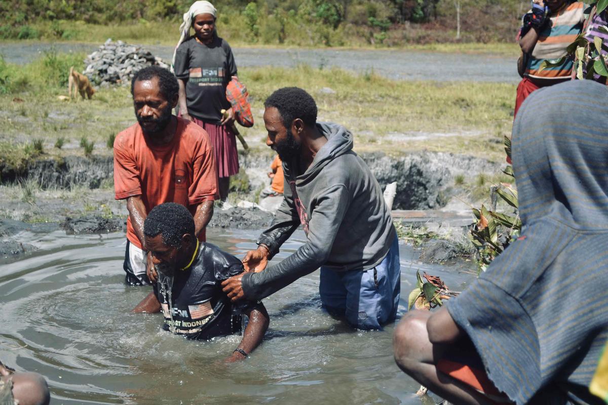 Wano tribesmen giving and receiving baptism in Papua, Indonesia. (Courtesy of <a href="https://www.wildbrothersproductions.com/off-the-couch-into-creation">The Wild Brothers</a>)