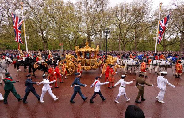 King Charles III and Queen Camilla travelling in the Gold State Coach, built in 1760 and used at every Coronation since that of William IV in 1831, goes down The Mall flanked by service men and women of the commonwealth during the Coronation of King Charles III and Queen Camilla in London, England, on May 6, 2023. (Richard Heathcote/Getty Images)
