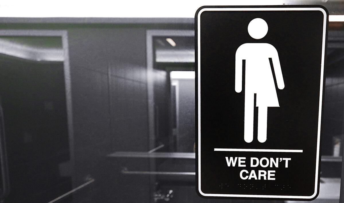 Gender neutral signs are posted in the 21C Museum Hotel public restrooms in Durham, North Carolina, on May 10, 2016. (Sara D. Davis/Getty Images)