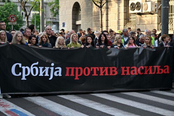 Demonstrators march behind a banner reading "Serbia against violence" in Belgrade on May 8, 2023, as they call for the resignation of top officials and the curtailing of violence in the media, just days after back-to-back shootings stunned the Balkan country. (Andrej Isakovic/AFP via Getty Images)